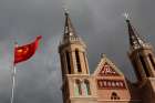 The Chinese national flag flies in front of a Catholic church in Huangtugang, China, Sept. 30, 2018. The Chinese government has targeted unregistered Catholic and Protestant churches with an expansion of rules and regulations governing religious organizations.