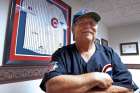 Father John W. Clemens, pastor of Our Lady of Hope Church in Rosemont, Ill., poses for a photo Oct. 27 near his jersey signed by Chicago Cubs legend Ernie Banks.