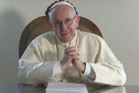 A screenshot shows Pope Francis smiling during a video message from the Vatican to young people of the Caribbean attending the July 10-23 youth assembly sponsored by the Antilles bishops&#039; conference. 