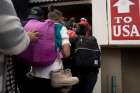 Central American migrants walk to the U.S.-Mexico border crossing April 29 in Tijuana, where they presented themselves for asylum. 