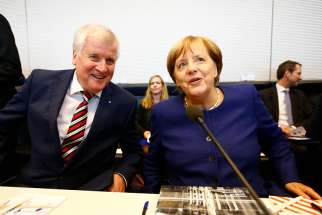 German political leaders Horst Seehofer and Chancellor Angela Merkel attend their first parliamentary meeting after the general election in Berlin. 