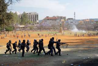 Police forces clash with protesters at the Union Buildings in Pretoria, South Africa, in this Oct. 23, 2015, file photo.