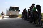 Immigrants turn themselves in to Border Patrol agents April 2 after illegally crossing the border from Mexico into the U.S., and wait to be transported to processing center near McAllen, Texas.