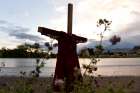 A child&#039;s red dress hangs on a stake near the grounds of the former Kamloops Indian Residential School in Kamloops, British Columbia.