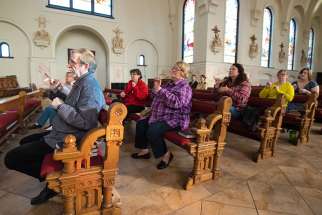 Members of the deaf community use sign language to participate in the Stations of the Cross held March 11 at St. John the Evangelist Church in Green Bay, Wis.