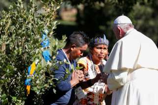Pope Francis greets members of an indigenous community of the Amazon during a celebration marking the feast of St. Francis in the Vatican Gardens Oct. 4, 2019.