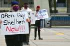 Protesters keep their distance at Toronto City Hall while demanding action for the homeless.