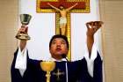 A priest celebrates Mass in a makeshift chapel in a village near Beijing in 2012. The Vatican has told bishops and priests in China that they must follow their own consciences in deciding whether to register with the government, and it urged Catholics in the country not to judge them for the choices they make.