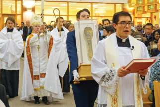 Some of the 80,000 people who came to see the relic hand and forearm of St. Francis Xavier on its cross-Canada tour, including stops at Calgary’s St. Albert the Great Church, above, and St. Francis Xavier Parish inv, Ont., right. 