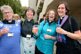Women priests in in York, England, react after the General Synod of the Church of England voted July 14 to authorize the ordination of women as bishops. The decision overturns centuries of tradition in a church that has been deeply divided on the issue.