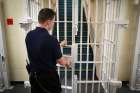 A prison guard locks a door during a visit by Britain&#039;s Deputy Prime Minister Nick Clegg and Justice Minister Chris Grayling to the Cookham Wood Young Offenders Institution in Rochester, southern England, on Jan. 16, 2014.