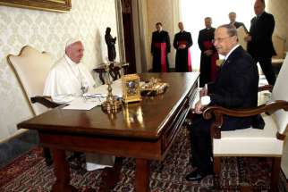 Pope Francis exchanges gifts with Lebanese President Michel Aoun during private meeting at the Vatican March 16.
