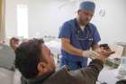 Dr. Anas Safadi, a cardiologist with the Syrian American Medical Society, checks his Syrian refugee patient Jan. 11 at Gardens Hospital in Amman, Jordan, after performing free heart catheter surgery the previous day.