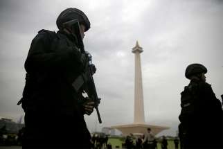 Armed policemen stand guard during a Dec. 21, 2017 ceremony ahead of the Christmas and New Year celebrations in Jakarta, Indonesia. Indonesia planned to deploy 250,000 security personnel across the country ahead of Christmas and New Year celebrations, particularly in Christian-majority areas. 