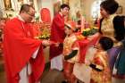 Fathers CheLong Bai and RunBao Zhang pass out red envelopes following Mass at St. Therese Chinese Church in Chicago&#039;s Chinatown at the start of the Chinese lunar new year in 2014.