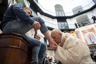 Pope Francis kisses the foot of an inmate during Holy Thursday Mass at Regina Coeli prison in Rome in this March 29, 2018, file photo. The pope will wash the feet of prisoners on Holy Thursday at Velletri Correctional Facility, about 36 miles south of Rome.