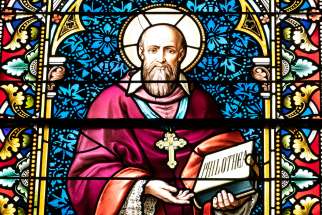 A likeness of St. Francis de Sales is seen in stained glass at Caldwell Chapel on the campus of The Catholic University of America in Washington in this May 25, 2021, file photo. Pope Francis in his message for World Communications Day said that the media and the field of communications need to exercise more kindness and share the truth with charity.