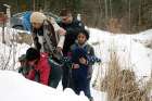 A woman and her family from Sudan are taken into custody after arriving by taxi and walking across the U.S.-Canada border into Quebec.