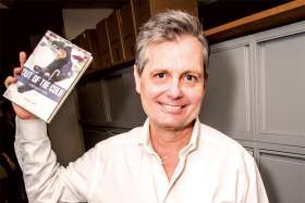 Michael Swan holds one of the first copies of his new book, Out of the Cold: A Caring History