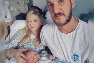 This is an undated handout photo of Chris Gard and Connie Yates with their son, Charlie Gard, provided by the family, at Great Ormond Street Hospital in London. 