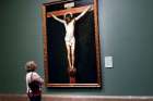 A visitor stands by Spanish artist Diego Velazquez’s painting The Crucified Christ in Madrid April 20.
