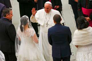 Pope Francis gestures to newlywed couples during his weekly audience in Paul VI hall at the Vatican 2015.