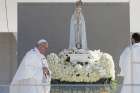 Pope Francis uses incense as he venerates a statue of Our Lady of Fatima during the canonization Mass of Sts. Francisco and Jacinta Marto, two of the three Fatima seers, at the Shrine of Our Lady of Fatima in Portugal, May 13. The Mass marked the 100th anniversary of the Fatima Marian apparitions, which began on May 13, 1917. 