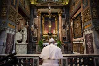 Pope Francis prays in front of a crucifix at the Church of St. Marcellus in Rome March 15, 2020. The crucifix was carried through Rome in 1522 during the &quot;Great Plague.&quot; The pope prayed as coronavirus deaths in Italy peaked at 368 in a 24-hour period, bringing the total number of deaths to 1,809 out of 24,747 cases.
