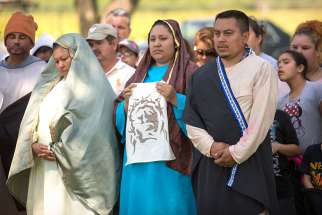 Catholics in Fresno, dressed in costume, participate in a Good Friday presentation of the Way of the Cross April 3, 2015. The tradition of a living Stations of the Cross is especially strong in the diocese&#039;s migrant communities.