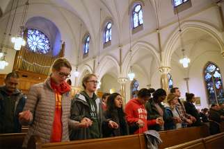 Students from Elizabeth Seton High School in Bladensburg, Md., pray during a March 24 Mass at St. Patrick Catholic Church in Washington. The Mass, sponsored by Catholic Charities of the Archdiocese of Washington, was celebrated to give students an opportunity to pray before participating in the March for Our Lives.