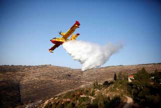 A plane drops fire retardant during a wildfire near Nataf, Israel, Nov. 26.