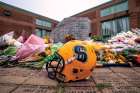 A memorial outside Msgr. Paul Dwyer Catholic High School in Oshawa, Ont., commemorates the Traynor family, four of whom were killed Sept. 4. Father Chris was a teacher at the school while daughter Adelaide was to enter Grade 10 this month. Other family members also attended the school.