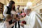 Accompanied by her children, Yahel and Naveh, Adi Shoham holds a poster of her husband, Tal Shoham, 39, during a meeting with Pope Francis at the Vatican Nov. 14, 2024. The Shoham family had been among those taken hostage by Palestinian militants Oct. 7, 2023.