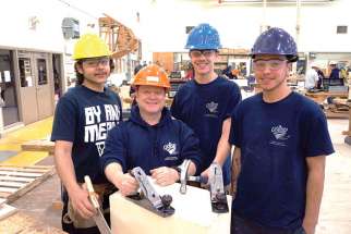 Archbishop Romero High School students Julian Wilson, Wesley Condran and Austin Pacheco, here with teacher John Zambri, are off to Kenya to build a school.