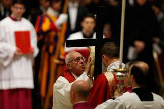 Pope Francis reverences the crucifix during the Good Friday service in St. Peter&#039;s Basilica at the Vatican March 25. 