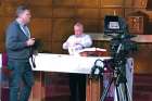 Deacon Mike Walsh prepares the altar before a taping of the Daily TV Mass.