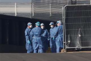 Medical staff are seen wearing protective clothing outside the Nightingale Hospital in London April 9, 2020. The Bishops&#039; Conference of England and Wales recommended that, because of the lack of personal protective equipment, during the COVID-19 pandemic priests should counsel patients by telephone rather than give them last rites.