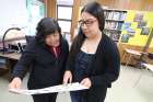 Aylin, a ninth-grader at La Salle Prep in Milwaukie, Ore., shares a recent school project in late May with her mother, Luz, who emigrated from Mexico. 