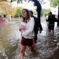 People wade through a flooded street after a rainstorm in Buenos Aires, Argentina, April 2. Affirming his closeness to his &quot;beloved Argentine people,&quot; Pope Francis offered his prayers for the victims of recent flooding in Buenos Aires and surrounding are as, and he urged government offices and private citizens to help those most in need.