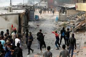 Iraqi demonstrators throw stones towards security forces during ongoing anti-government protests in Baghdad Nov. 29, 2019. Pope Francis said after the Angelus Dec. 1 he was concerned and saddened following two months of protests in Iraq that resulted in the deaths of hundreds of people.