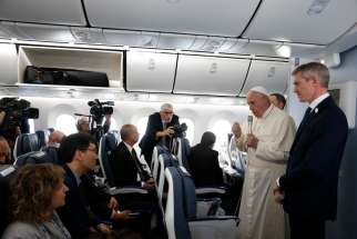 Pope Francis answers questions from reporters aboard his flight from Tokyo to Rome Nov. 26, 2019.