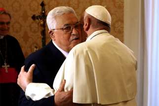  Palestinian President Mahmoud Abbas embraces Pope Francis during a meeting at the Vatican Dec. 3.