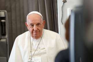 Pope Francis listens to a question from a journalist aboard his flight back to Rome Sept. 13, 2024, after visiting Indonesia, Papua New Guinea, Timor-Leste and Singapore. It was his 45th and longest foreign trip.