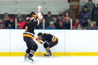 Fr. John Perdue launches a surprise at a teammate and an unsuspecting audience during a charity game in Mattawa, Ont.