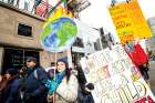 Protesters send some strong messages as they march down Yonge Street on Black Friday.