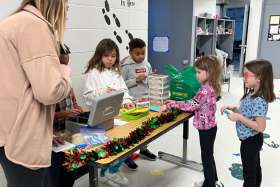 Young students hold a Christmas Candy Cane Drive to support the Dreams for Kids campaign.