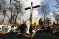 A man kneels in prayer in front of a statue of Mary and a crucifix by a barricade near Independence Square in Kiev, Ukraine, Feb. 21. Scores of protesters were killed and hundreds were wounded by snipers on Kiev&#039;s Independence Square and its nearby stree ts, according to medical workers treating the victims.