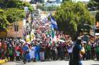 A large caravan of migrants from Central America, trying to reach the U.S., walks along a road Oct. 21 in Tapachula, Mexico. 