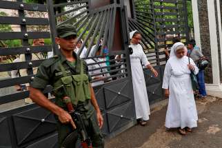 A soldier keeps guard as nuns walk out of St. Sebastian Church in Negombo, Sri Lanka, April 30, 2019. Catholic leaders canceled Sunday Masses as Sri Lanka&#039;s churches remained closed for a second week for fear of new terrorist attacks after the Easter Sunday suicide bombings that killed more than 250 people.