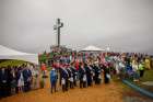 People stand near a 60-foot illuminated cross Aug. 12 at Holy Land USA, a former theme park in Waterbury, Conn., during a Mass honoring sainthood candidate Michael McGivney, founder of the Knights of Columbus and a native of Waterbury.